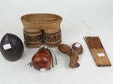 several items including a basket, a knife, and other items on a white surface
