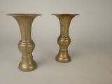 pair of antique brass vases on a white background