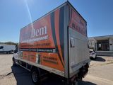 a truck parked in a parking lot with a building in the background