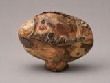 a close up of a wooden bowl with a fish on it