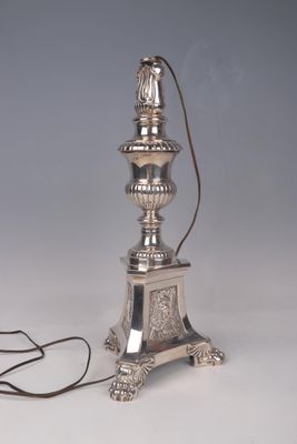 an antique silver plated lamp with a cord attached to it