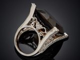 a close up of a black diamond ring on a black surface