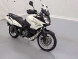 a white and black motorcycle parked in a room