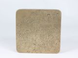 an antique brass cigarette case with a design of people on it