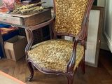 a chair that is sitting in front of a table with a clock on it