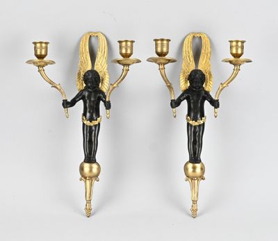 deux bougies noires et dorées ornées d'anges, sur fond blanc