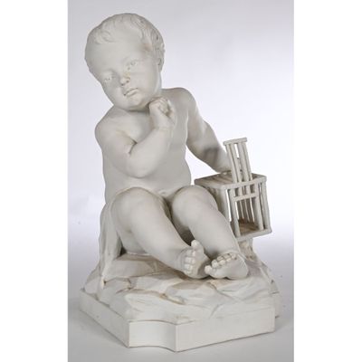 an image of a statue of a child sitting on a rock