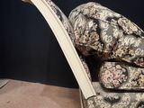 a chair with pillows on top of it in a room