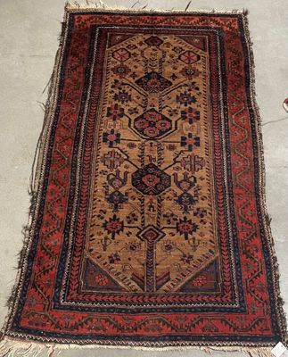 an old rug is laying on the floor next to a pair of scissors