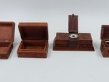 three small wooden boxes with a dice in them on a white surface