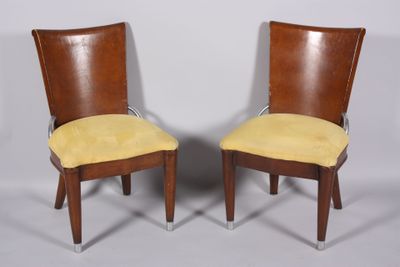 pair of mid century style chairs with yellow upholstered cushions