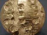 an image of a close up of a gold medal on a table
