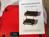 two red trays on a table with a price tag on them
