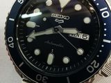 a close up of a watch on a white surface