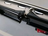 a close up of a laptop with a red button on it