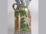 a large vase with a painting on it sitting on a table