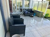 an image of a patio with a couch and chairs