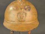 an old yellow helmet with a horse on it sitting on a metal stand