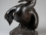 bronze sculpture of a duck sitting on a base