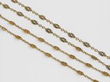three gold chain necklaces on a white background