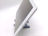 a tablet computer sitting on a stand on a white surface