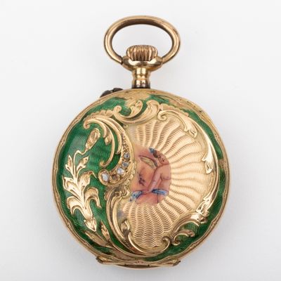 a gold and green pocket watch with a painting on it