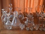 a lot of glass bottles sitting on a wooden table