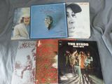 a lot of records that are on a bed