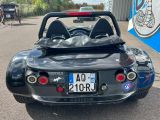 a black sports car parked in a parking lot