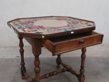 a small wooden table with a drawer on it