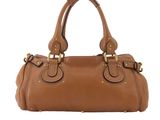a brown leather handbag on a white background