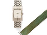 an image of a watch and a green strap on a white surface