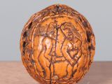 a wooden ball with carvings on it sitting on a table