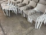 a lot of white chairs that are sitting in a warehouse