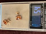 a small electronic scale with a pair of earrings on it