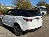 a white range rover parked in a parking lot