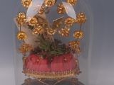 a glass dome with a gold decoration on top of it