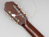 an acoustic guitar with strings attached to it sitting on a table