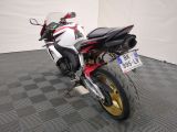 a white and red motorcycle parked in a room