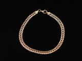 a gold bracelet on a black background
