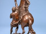 bronze statue of a man on a horse with a man on a horse