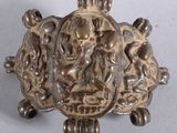 a silver brooch with a picture of a man and a woman on it