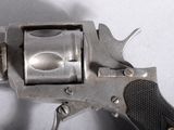 a silver revolver with a black handle on a white surface