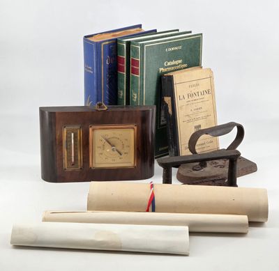 several books, a clock, a book case, and a pair of scissors sit on a white surface