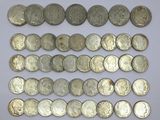 a close up of a pile of silver coins on a white surface