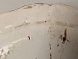 a white toilet with a rusted seat in a bathroom