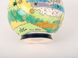 a vase that has a picture of a landscape on it
