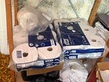 several rolls of toilet paper sitting on top of a shelf next to a window