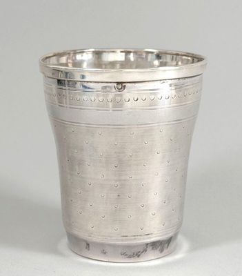a silver cup that is sitting on a table