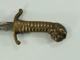 a bronze sword with a lion head on it